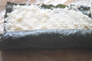 Roll from the bottom using the plastic at first and then your hands